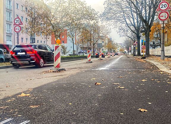 Zwischen Martin-Luther-Straße und Bayerischem Platz ist eine frisch asphaltierte Fahrbahn am rechten Rand durch einen weißen Streifen und Baken von der Spur für Autos weiter in der Mitte abgegrenzt. 